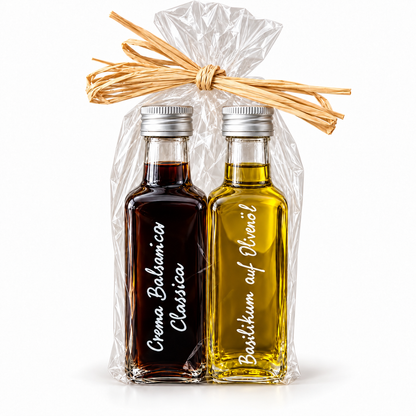 Geschenkset Crema Balsamica Classica und Basilikum auf Olivenöl, je 100 ml, in Cellophan mit Bast