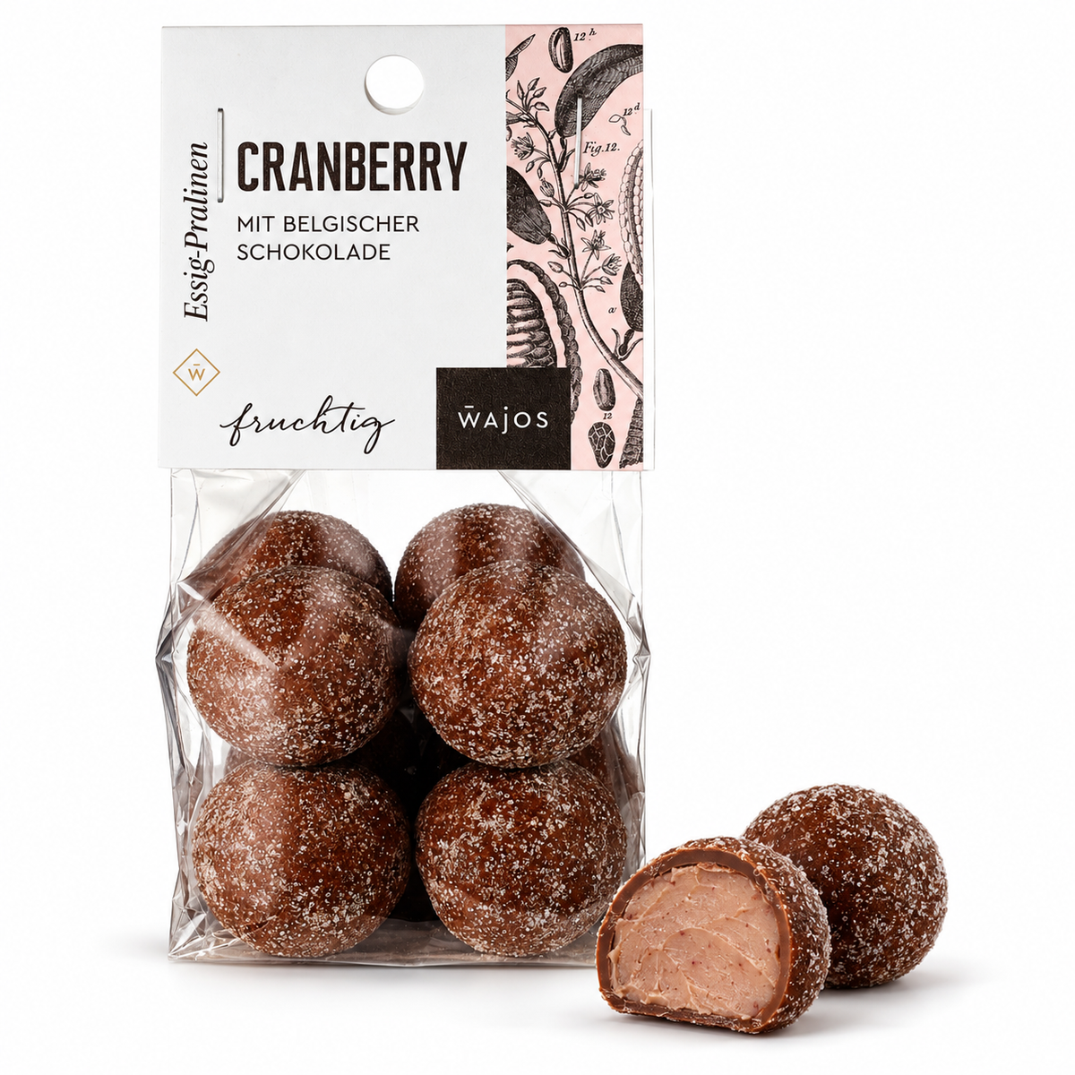 Cranberry-Essig-Pralinen von Wajos – 100-g-Packung, ganze Praline und Anschnitt auf weißem Hintergrund